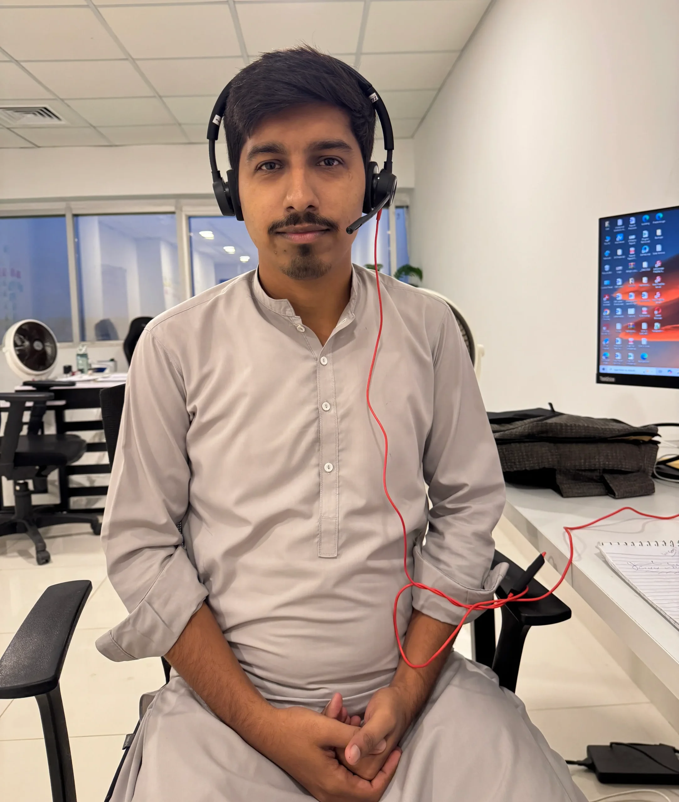 Muhammad Hammad, WordPress and automation developer, at his office workstation.